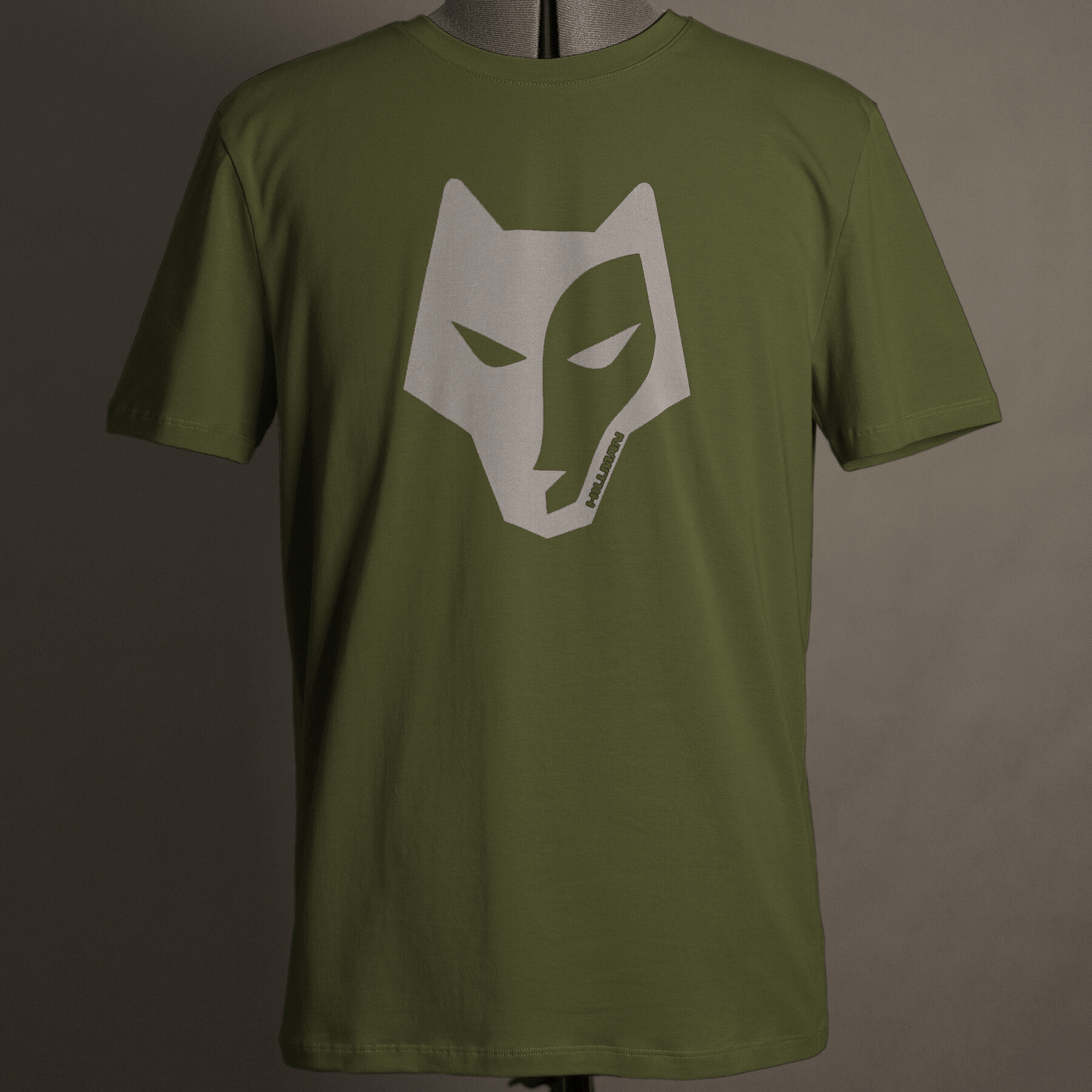 The Hillman® Alpha T-shirt in olive green is crafted from fine Italian Egyptian cotton, shown on a mannequin with a striking white stylized wolf head graphic centered on the chest.
