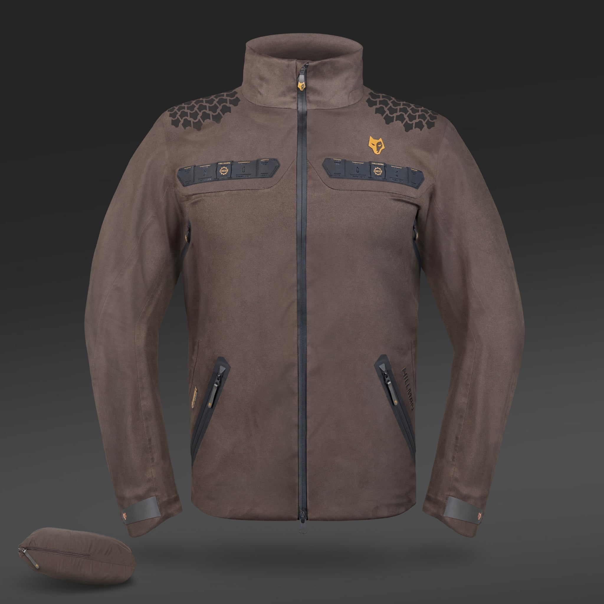 A brown HILLMAN GEAR 5WL Waterproof Camo Hunting Rain Jacket with a high collar, prominent zipper, and multiple zippered pockets. Ultra-lightweight construction with hexagonal shoulder pattern, a chest fox logo, and accompanied by a matching side pouch.