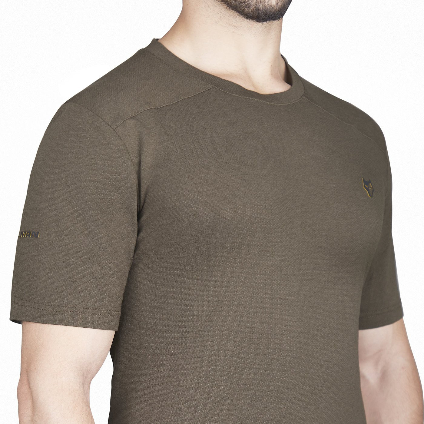 A person wearing a Hillman® 1UL Bamboo Short Sleeve Hunting T-shirt with Active Vent Technology in olive green, featuring a small embroidered logo on the chest and an emblem on the sleeve. The person's face is not visible.