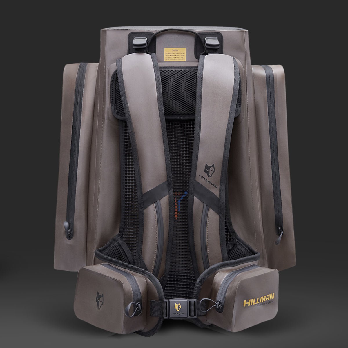 The Hillman® Chairpack XWP40 is a brown, modern waterproof hunting backpack with a built-in chair, featuring wide structured straps, mesh padding, two rectangular side pouches, MOLLE system, and the “HILLMAN” logo in yellow on the bottom right pouch.