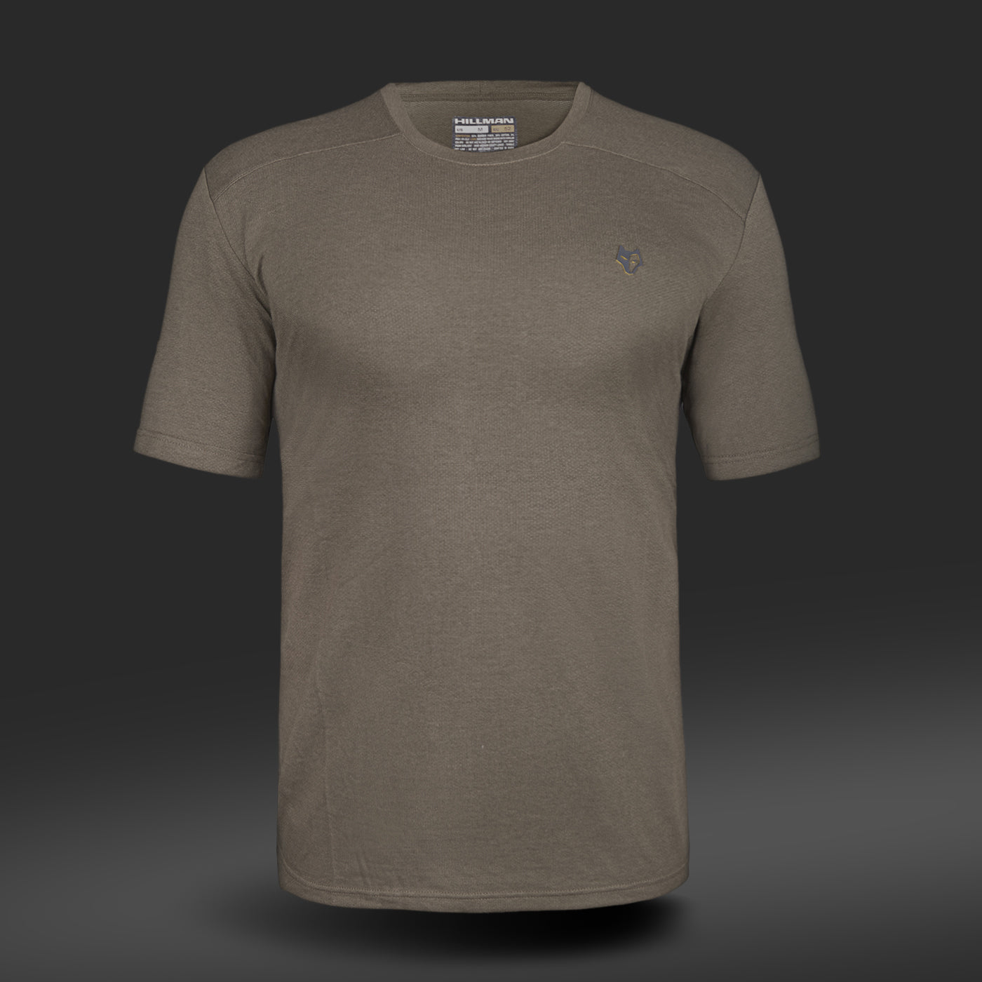 The 1UL Bamboo Short Sleeve Hunting T-shirt by HILLMAN is displayed against a dark gradient background. It includes an embroidered logo on the left chest, a visible collar tag, and is made with bamboo fiber for comfort and sustainability.