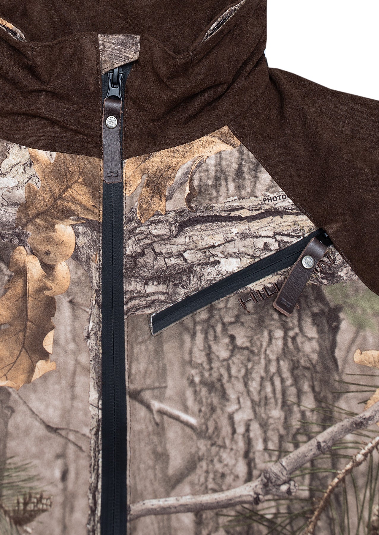 The Hillman® Waterproof Insulated Hunting Jacket | Fusion features a black central zipper, a zippered chest pocket with a leather pull tab, a brown hood and shoulders, and a tree bark and leaf camouflage pattern.