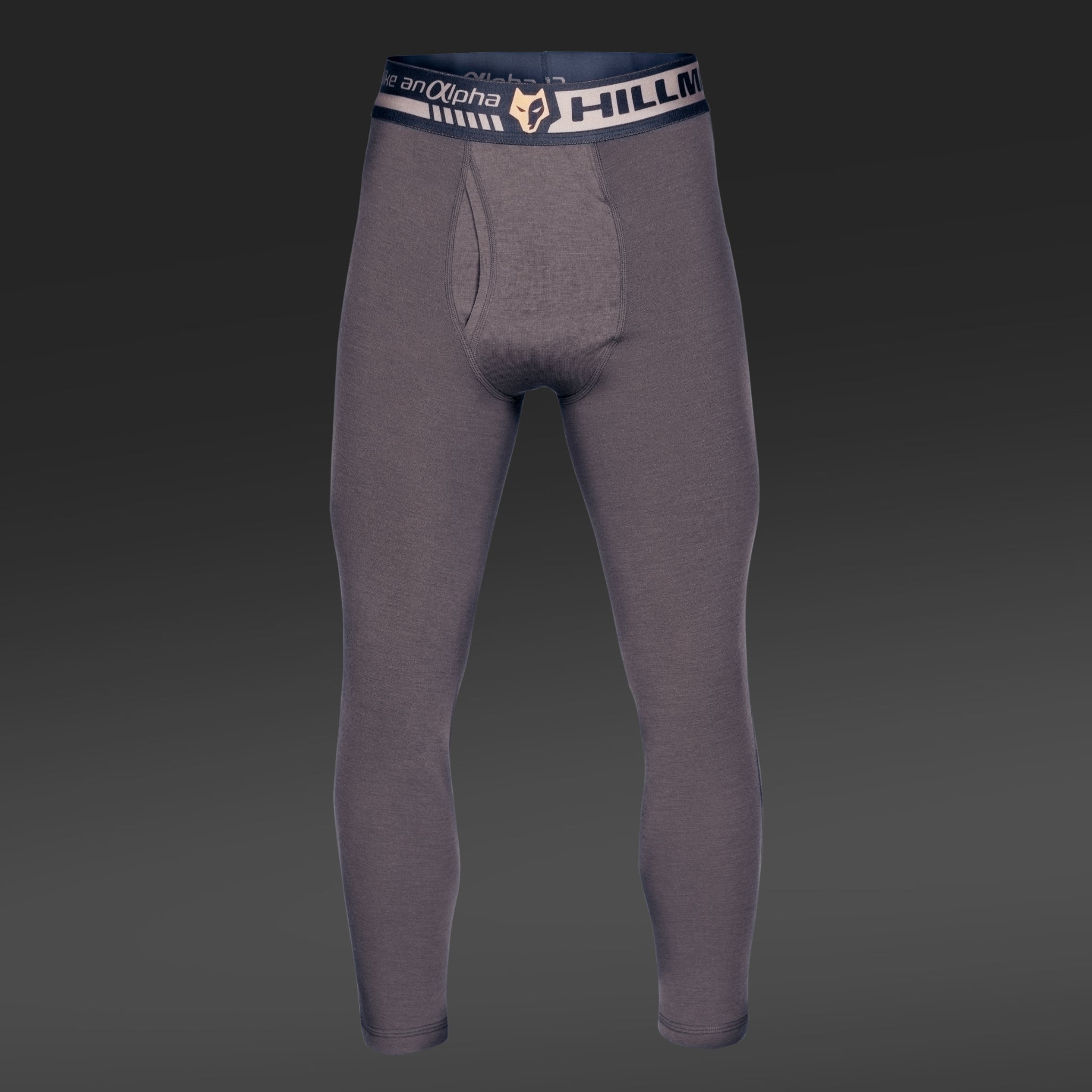 Gray 2BL Merino Wool Hunting Long Johns, featuring a black waistband boldly printed with Hillman®GWR, stand out on a dark gradient background. This thermal base layer is showcased from the front.