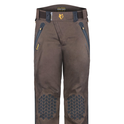 HILLMAN GEARs 5WL Waterproof Camo Hunting Pants are ultra-lightweight and feature reinforced hexagonal knee pads, two front zippered pockets, and belt loops. A yellow and black logo adorns the waistband. Durable for outdoor activities.