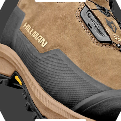 Close-up of the DRYHUNT 2.0 Waterproof Hunting Boots by HILLMAN, showcasing a brown design with a black rubber sole and details. The boots feature a mountain logo and the Hillman name, with textured tread patterns and lace loops enhancing their rugged performance appeal.